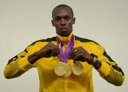 Bolt with his three Olympic gold medals at the 2012 Summer Olympics in London