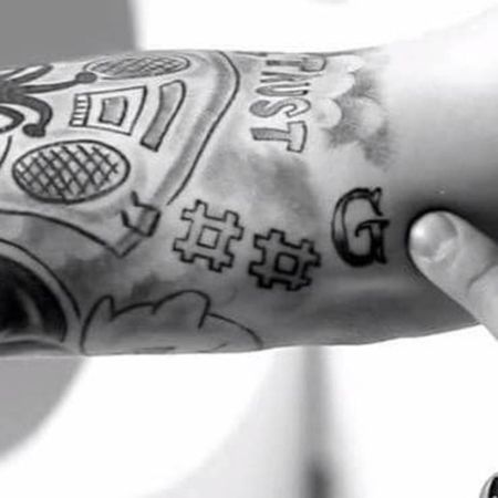 Justin's "G" tattoo