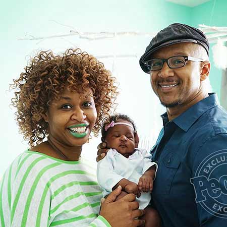 GloZell with her newborn baby and husband, Kevin Simon. 